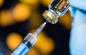 Needle and syringe into vaccine vile